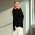 Load image into Gallery viewer, Woman wearing a black sweater over a white dress on a white background
